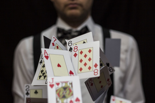 Man with flying playing cards