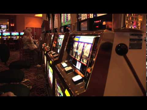Slot Machine Player Winning a Payout Slip in a Las Vegas Australian Casino after Playing a Bonus Reels Game